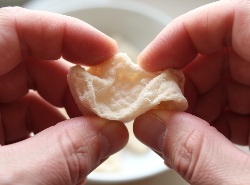 Hand snapping a piece of freeze dried food to check it for residual moisture in the center